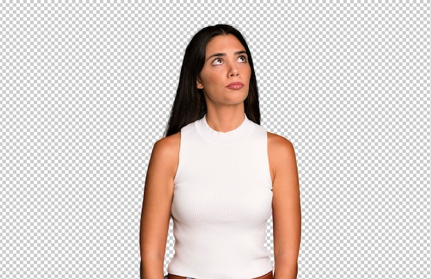 with a worried confused clueless expression looking up to copy space doubting
