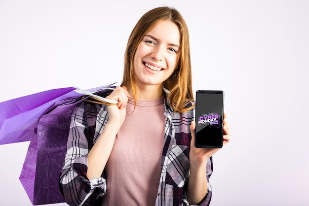 Woman carrying paper bags and holding a phone mock up