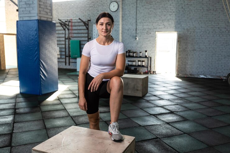 PSD woman in gym posing on a step box getting ready for training
