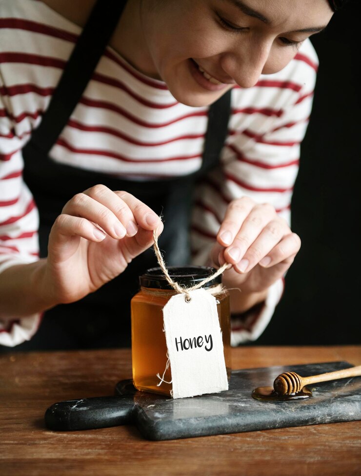 PSD woman packing organic honey into a jar