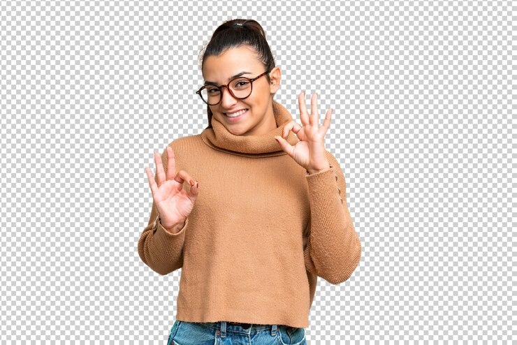 PSD young beauty woman over isolated chroma key background showing ok sign with two hands