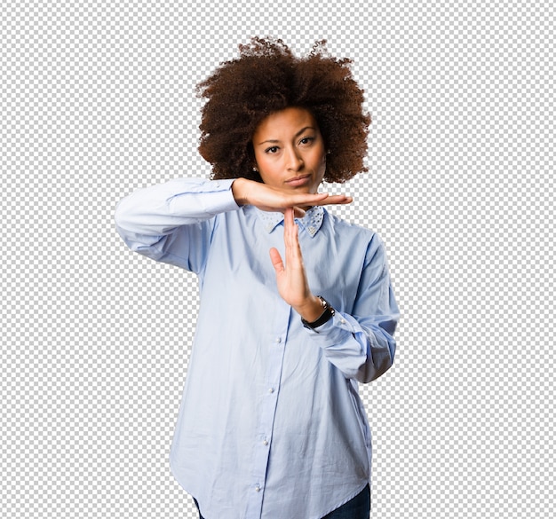Young black woman doing time break gesture