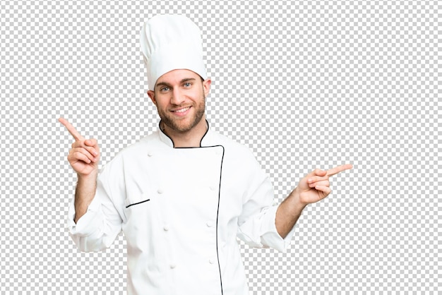 Young blonde man Chef over isolated chroma key background pointing finger to the laterals and happy