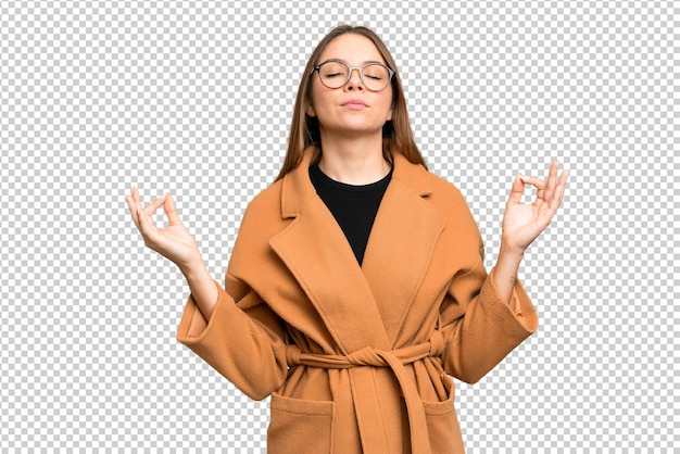 Young blonde woman over isolated chroma key background in zen pose