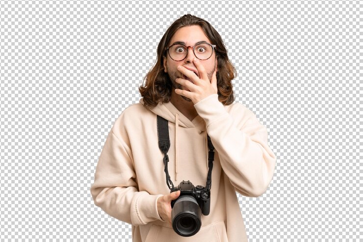 PSD young photographer man over isolated background surprised and shocked while looking right