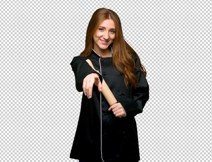 PSD young redhead chef woman points finger at you with a confident expression