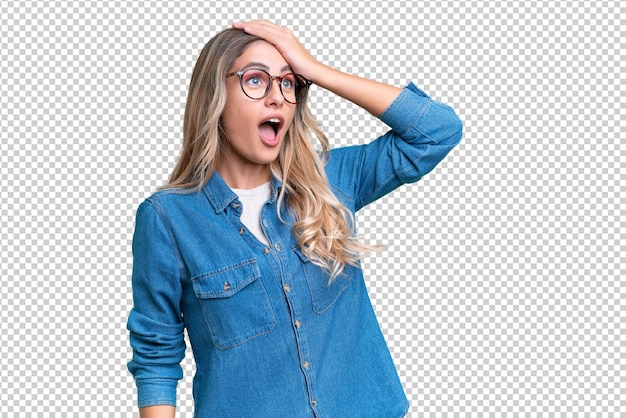young uruguayan woman over isolated background doing surprise gesture while looking to the side
