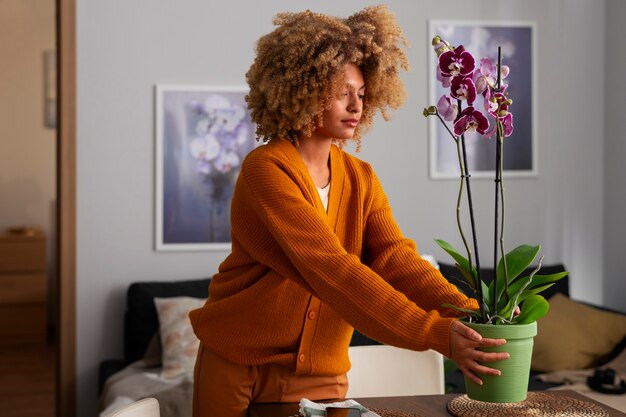 close up on woman decorating her home with orchids