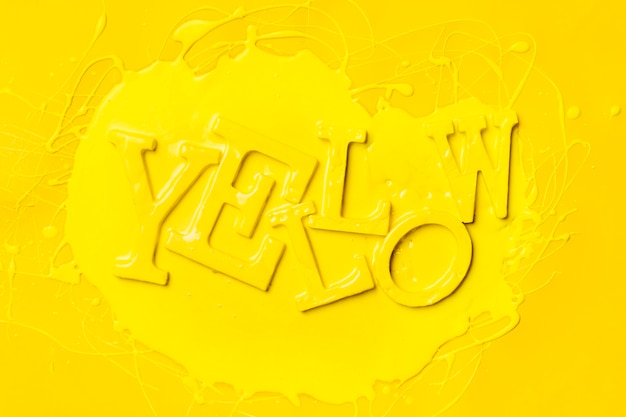 flat lay of word yellow with paint