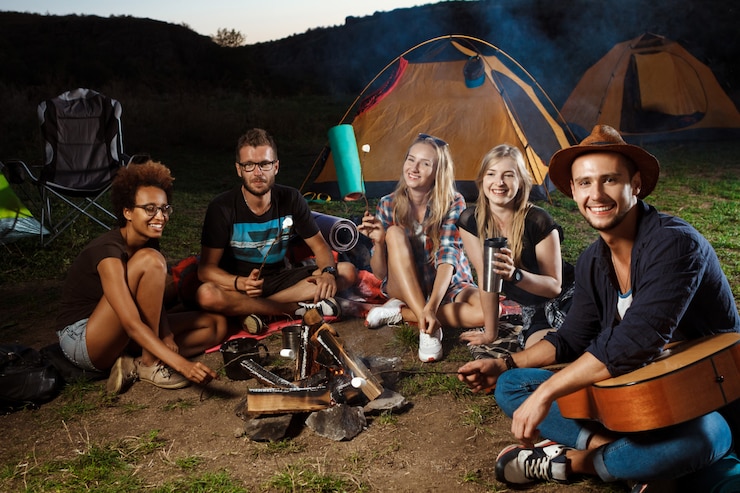 Ücretsiz Fotoğraf friends sitting near bonfire, smiling, playing guitar camping grill marshmallow.