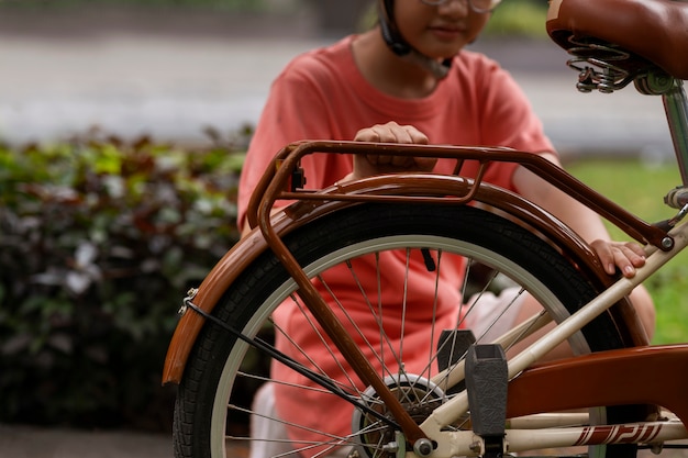 front view girl cycling outdoors