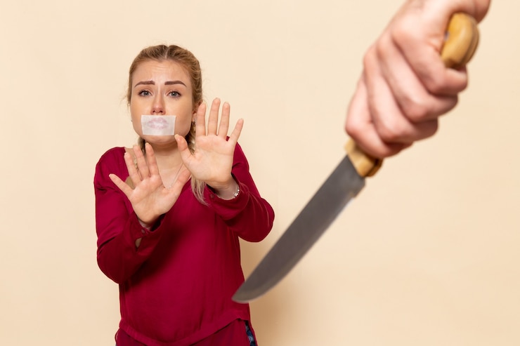 Ücretsiz Fotoğraf front view young female in red shirt with tied mouth scared of knife on the cream space female cloth  photo violence domestic