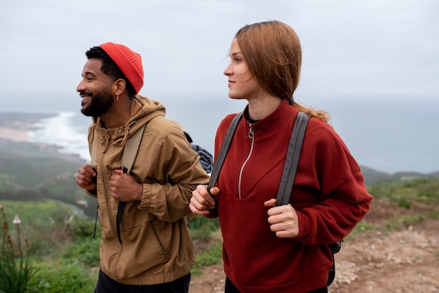 medium shot couple hiking together