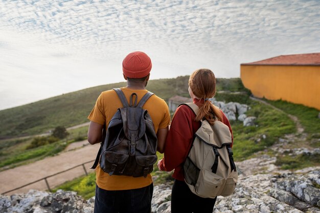 medium shot couple hiking together