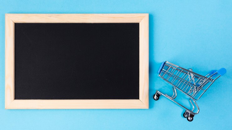 Ücretsiz Fotoğraf shopping cart near blank blackboard