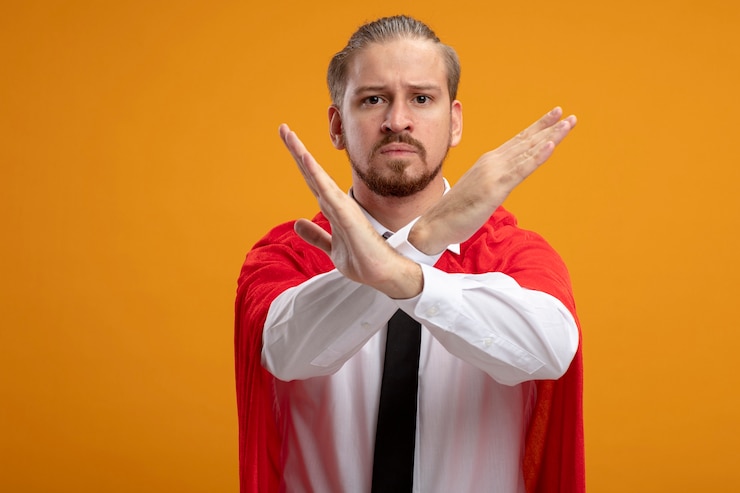 Ücretsiz Fotoğraf strict young superhero guy looking at camera wearing tie showing gesture of no isolated on orange background