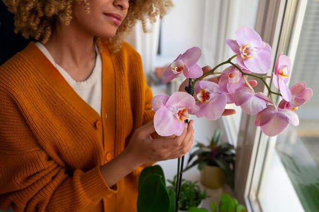 woman decorating her home with orchids