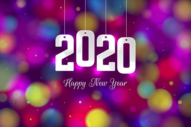 Vecteur gratuit fond coloré de nouvel an 2020 floue