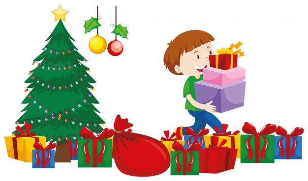 Garçon avec des boîtes à cadeaux sous un arbre de Noël
