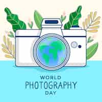 Vecteur gratuit journée mondiale de la photographie avec des feuilles et un appareil photo