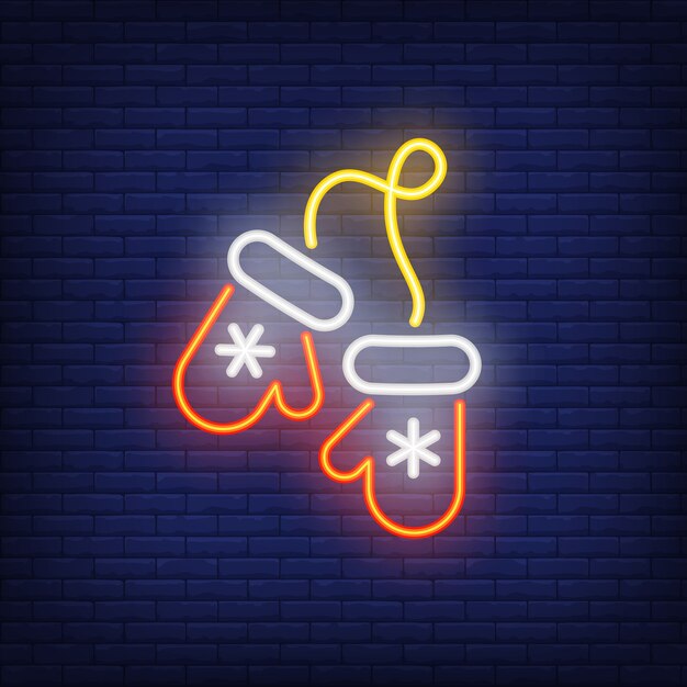 Mitaines de Noël au néon avec des flocons de neige. Élément de publicité lumineuse de nuit.