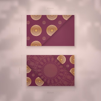 Modèle de carte de visite bourgogne avec motif doré vintage pour votre marque.