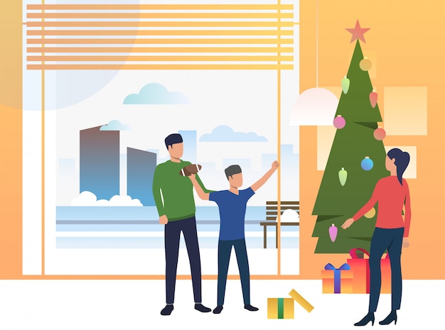 Vecteur gratuit parents et enfants offrant des cadeaux de noël