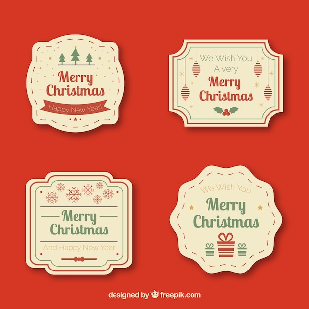 Quatre Badges De Noël Sur Un Fond Rouge