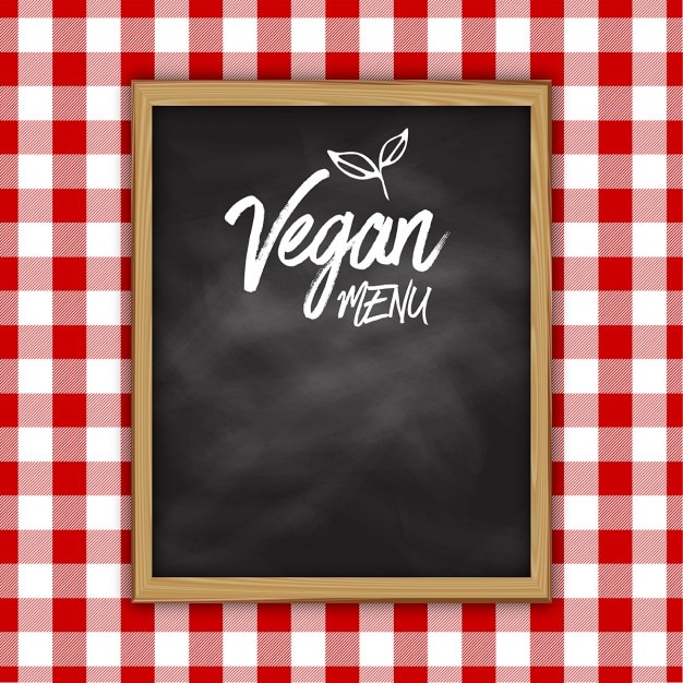 Vecteur gratuit vegan conception menu tableau noir sur un fond de tissu vichy