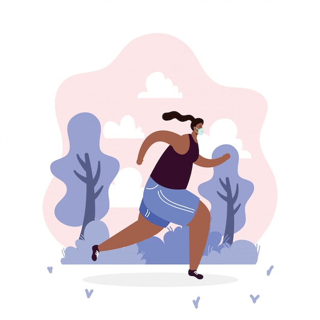 Afro woman wearing medical mask running sport dans le parc