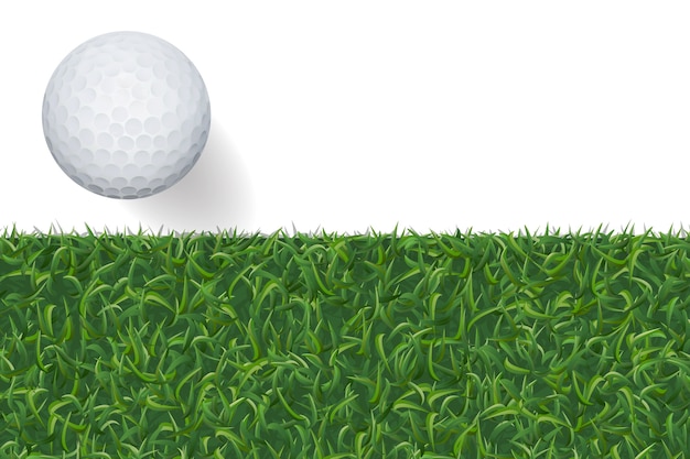 Balle de golf et fond d&#39;herbe verte.