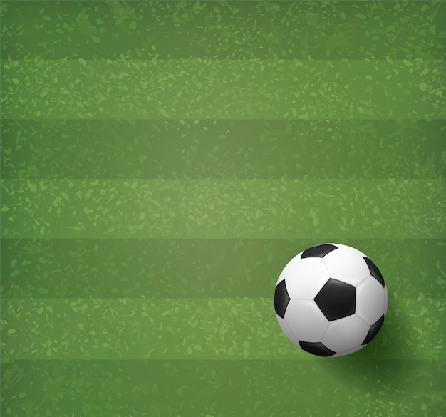 Vecteur ballon de football de football sur fond de champ d'herbe verte.