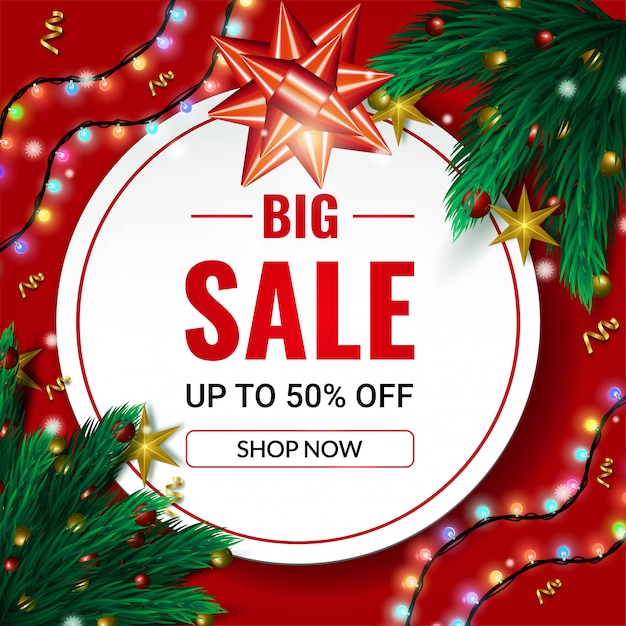 Bannière de grande vente de Noël jusqu’à 50% de réduction avec des branches d’épinette et des guirlandes rouges