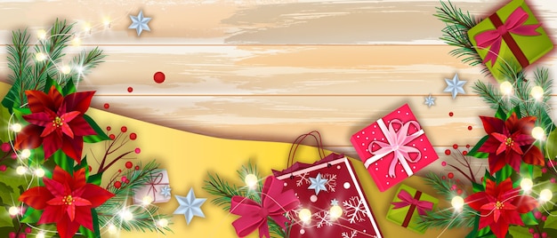 Bannière d'hiver de Noël avec coffrets cadeaux de vacances, feuilles de poinsettia rouges, branches de sapin. vue de dessus