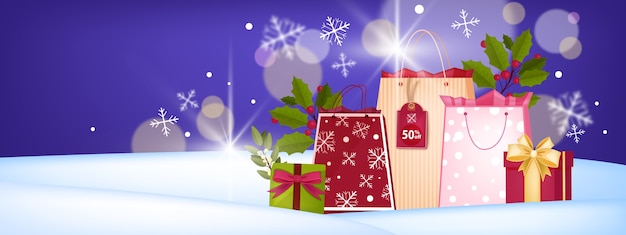 Vecteur bannière de vente de vacances d'hiver de noël et du nouvel an avec sacs à provisions, coffrets cadeaux, dérives de neige