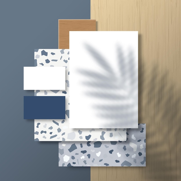 Cartes de visite et dépliant sur la surface de carreaux de terrazzo et de bois avec une superposition d'ombre de feuilles de palmier tropical