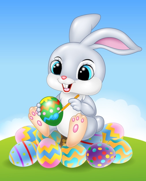 Cartoon Lapin de Pâques peignant un oeuf sur les oeufs de Pâques