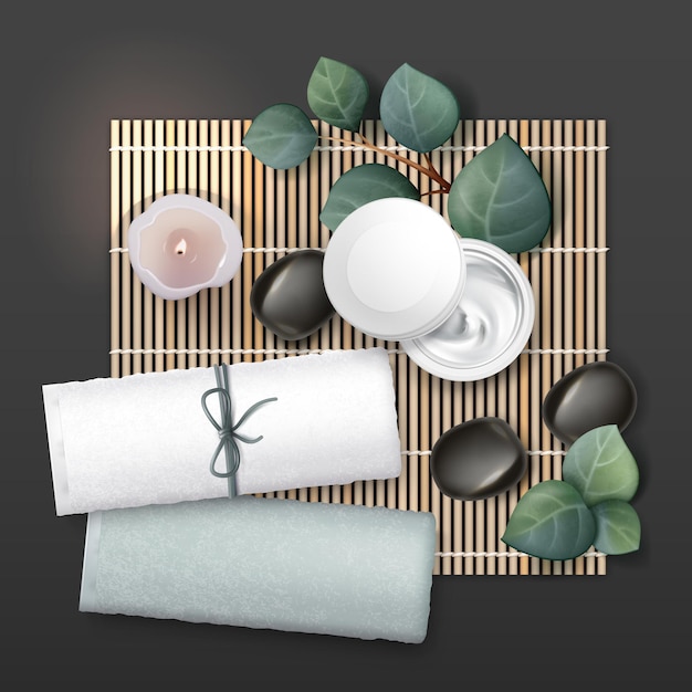 Composition d'accessoires de massage. Crème, bougie, pierres, serviettes, plantes.