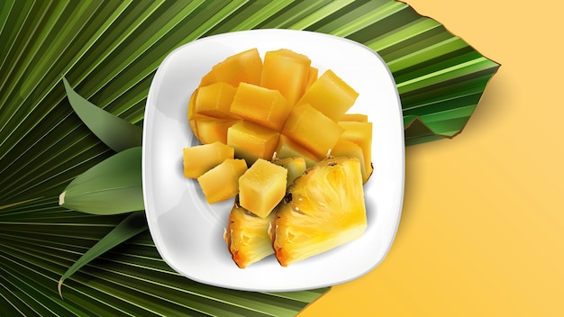 Composition de tranches d'ananas et de mangue en dés sur une plaque blanche et des feuilles.