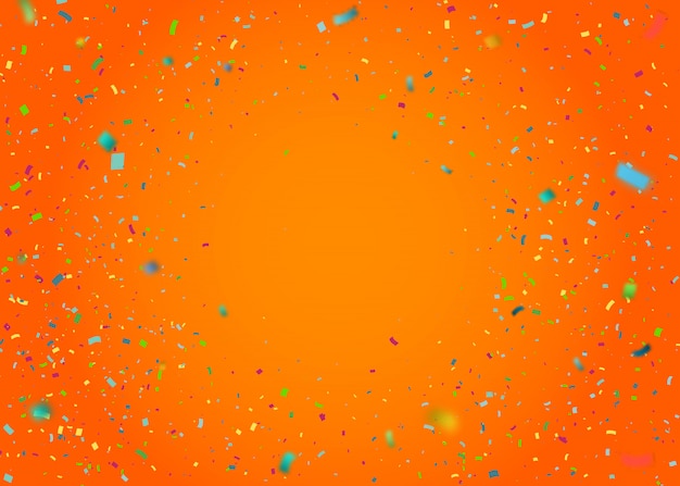 Confettis colorés sur fond orange
