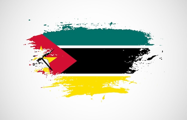 Vecteur coup de pinceau grunge avec le drapeau national du mozambique sur un fond blanc isolé