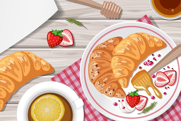 Croissant aux fraises et une tasse de thé au citron sur la table