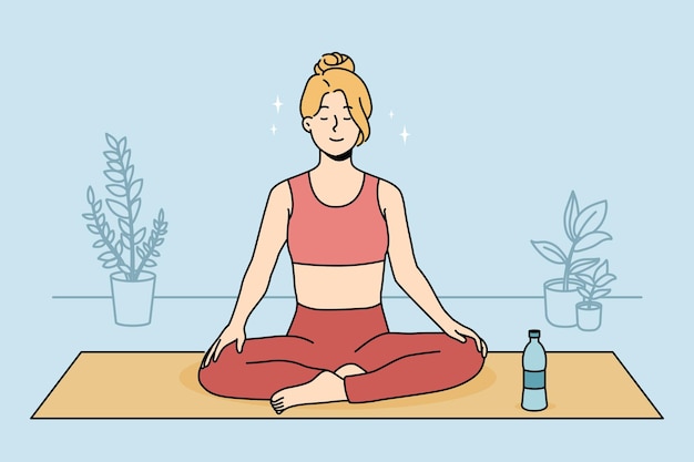 Femme calme pratiquant le yoga à la maison