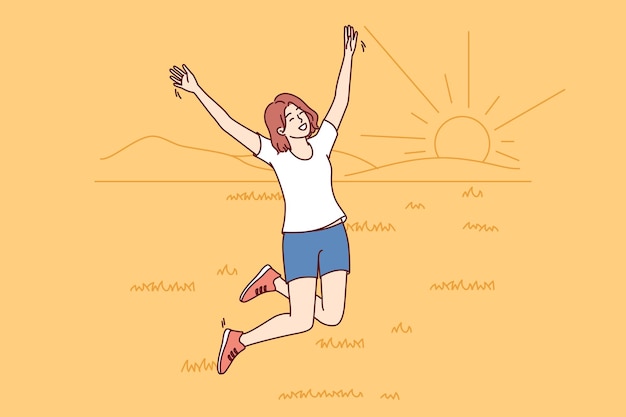 Une femme heureuse sautant dans un champ d'été avec de l'herbe et profitant d'un paysage naturel avec le coucher de soleil