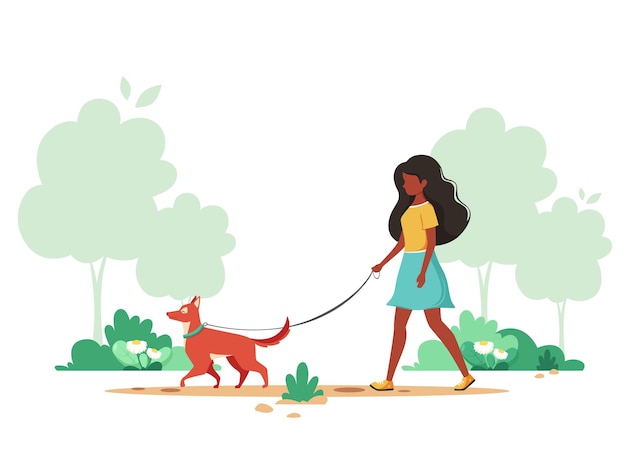 Femme noire marchant avec un chien au printemps Activité de plein air