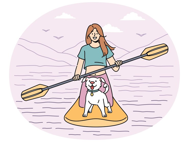 Une femme souriante avec une voile de chien sur une planche à pagaie