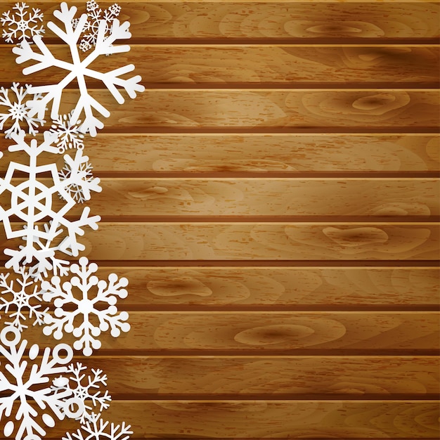 Fond avec des flocons de neige blancs sur des planches de bois marron