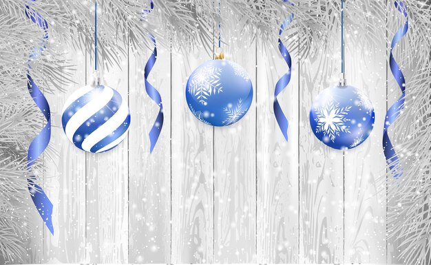 Vecteur fond de noël et du nouvel an avec des boules de noël bleues, une serpantine et une branche en forme. neige sur un fond en bois blanc, illustration vectorielle.