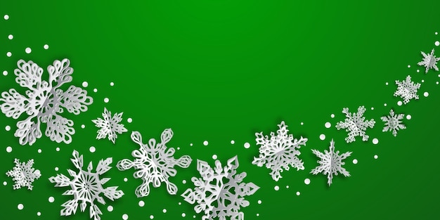 Fond de Noël avec des flocons de papier de volume avec des ombres douces sur fond vert