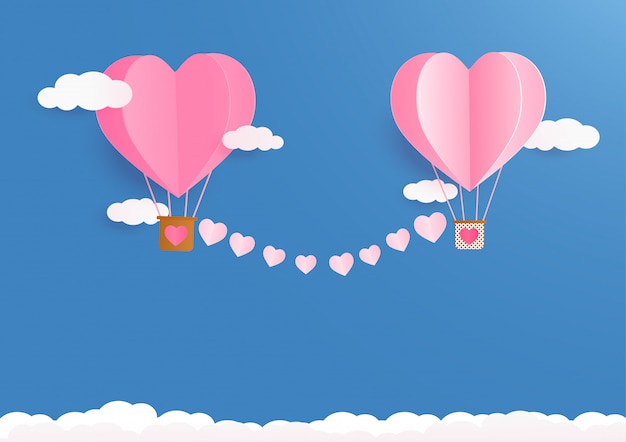 Fond de Saint Valentin avec des ballons coeur et des nuages.